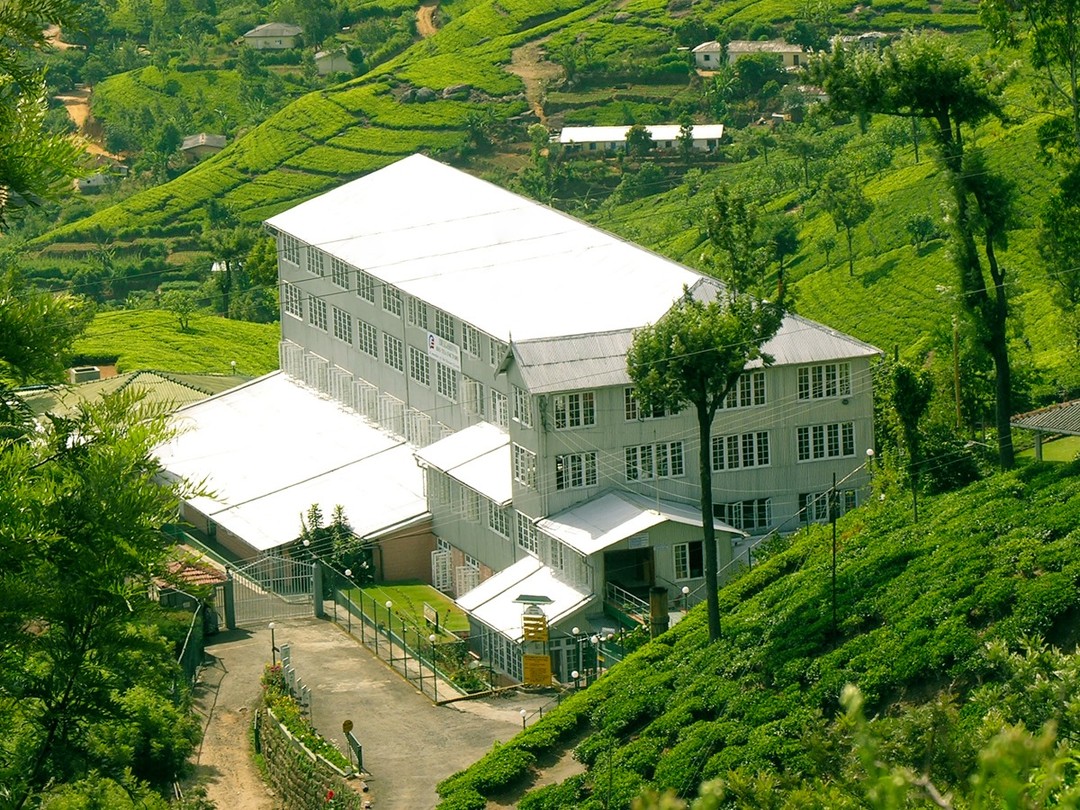 Tea factory surrounded by plantation hills at Gowerakelle Estate in Uva Province